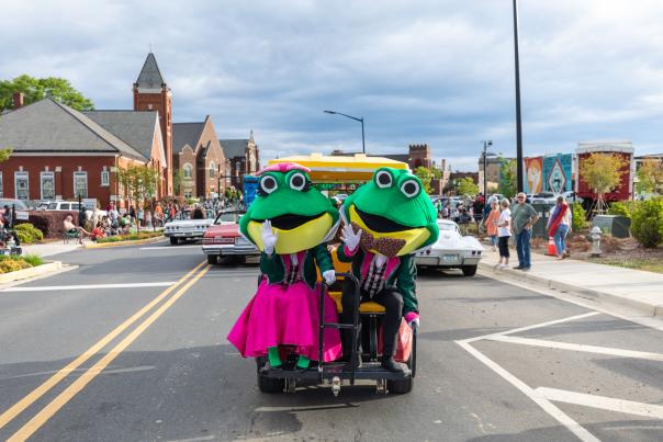 Two frog mascots for Come See Me Parade