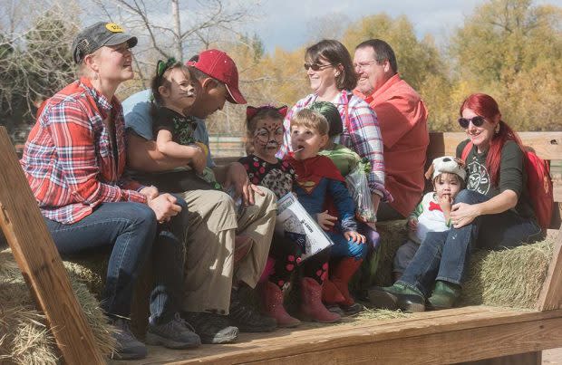 children and parents on hay wagon