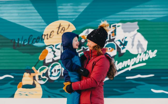 Settlers Green - Mother and Son Standing in Front of Mural, Wintertime