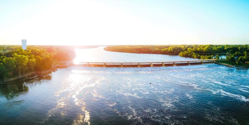 The sun rises above Coon Rapids Dam in Brooklyn Park, MN