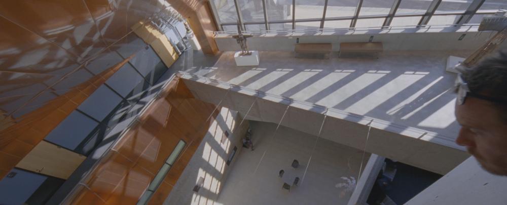 Song to Song screengrab, Cook looks down at the atrium inside Austin City Hall