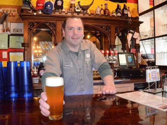 Charles Grantier serves a beer at Territorial Brewing