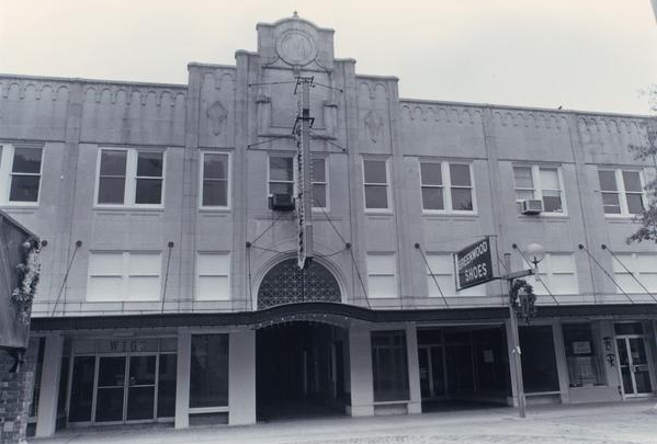 black and white photo of the arcade theater a multi story building with an awning
