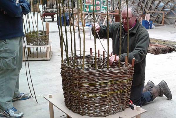 a person making a willow chair