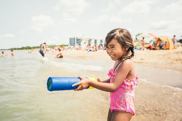 girl playing in water at Grand Bend beach