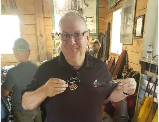 A Mackinac Island visitor shows off the custom knife he made using traditional blacksmith techniques at Forge A Memory.