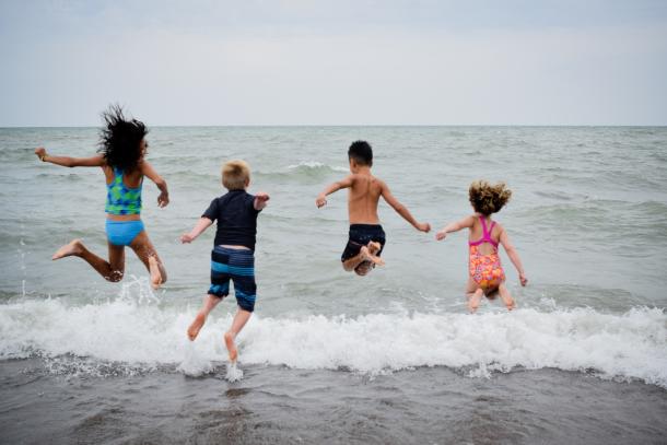 Children jumping into water