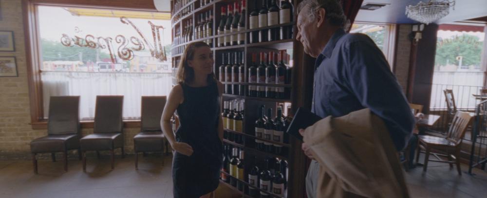 Song to Song screengrab, showing Faye talking to her father inside Enoteca Vespaio