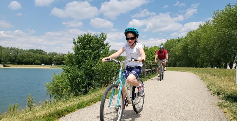 Man and Girl Biking Lake Andrea Paved Path