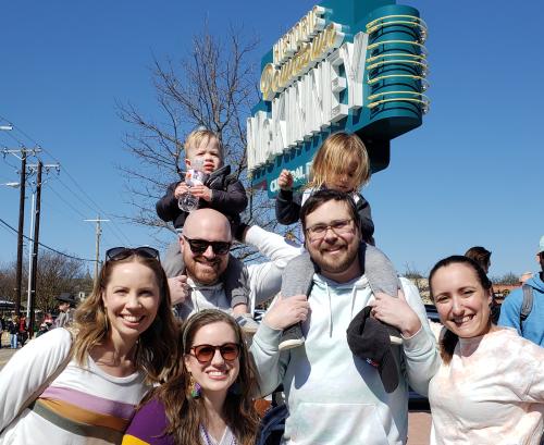 Family posing by downtown McKinney sign