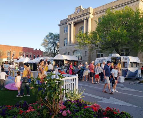 Arts in Bloom scene in Downtown McKinney - MPAC in background of pic