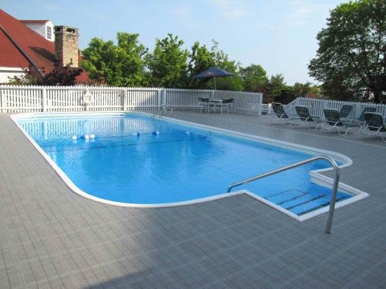 A heated outdoor swimming pool with hot tubs is located on the grounds of Mackinac Island’s Mission Point Resort.