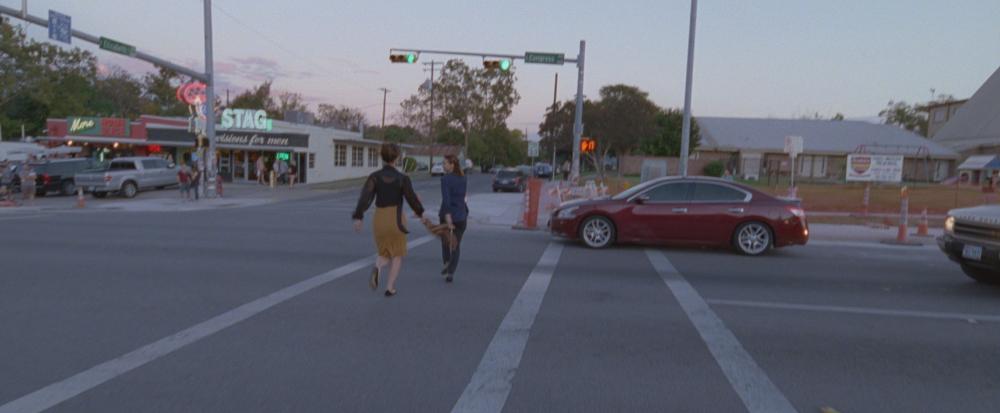 Song to Song screengrab two women dance in the crosswalk on South Congress near Home Slice Pizza