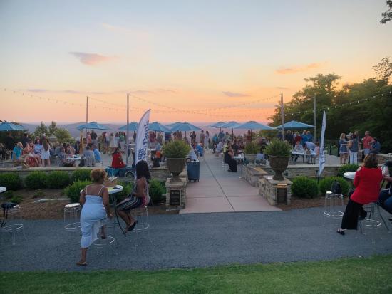 The bustling patio seating area at Burritt on the Mountain at sunset.