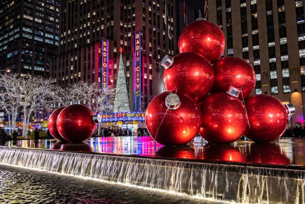 Giant red ornaments set atop a fountain outside Radio City Music Hall