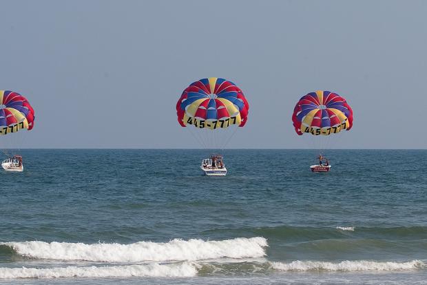 Three parasailing boats off shore