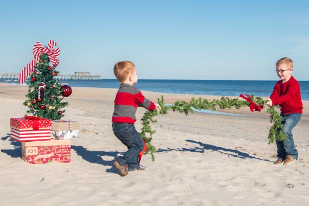 Christmas Tree with Boys playing Tug of War with Garland on the Beach
