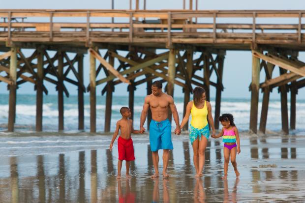 family walking near pier in Myrtle Beach