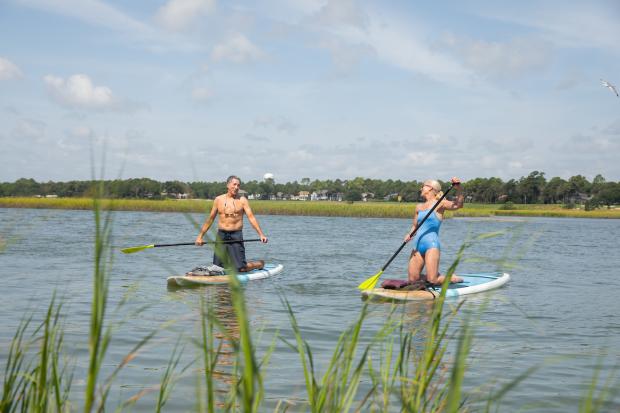Couple paddleboarding in the inlet together