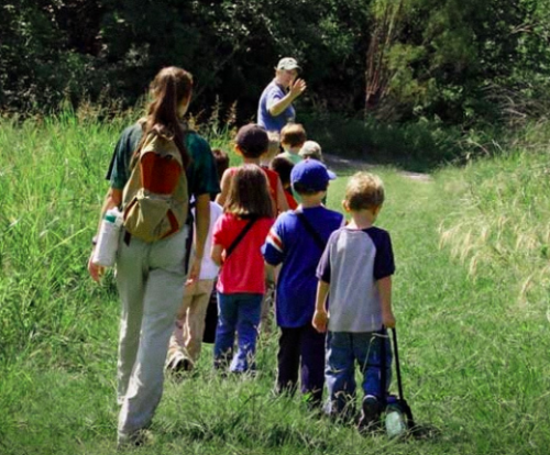 Spring Break camps at the Heard - kids standing in line on a nature trail