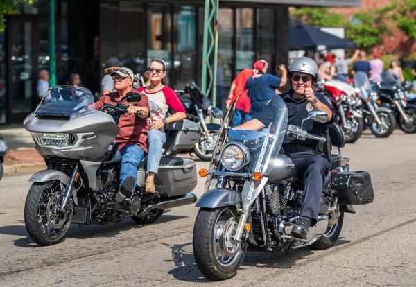 A police officer gives a thumbs up as he rides down Garrison Avenue at the Steel Horse Rally.