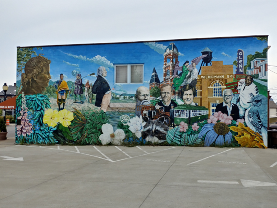 Street art in Newport Kentucky depicting famous people and places from the area in one art mural