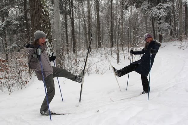 Staffers Becky Hill and Emily Douglas kick up their heels (in a snowier winter!) at Palmer Woods. Photo courtesy of Leelanau Conservancy.