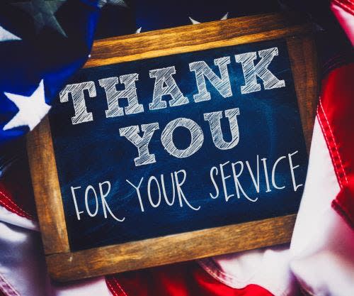 A chalkboard that says Thank You For Your Service with an American flag around it