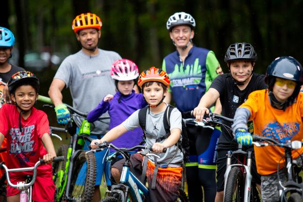 Children and adults getting ready to go mountain biking