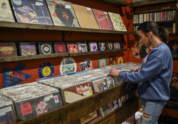 A women browses vintage records at Brick City in Fort Smith.