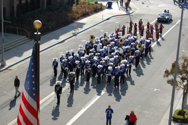 Band marches on street during Veterans Day parade