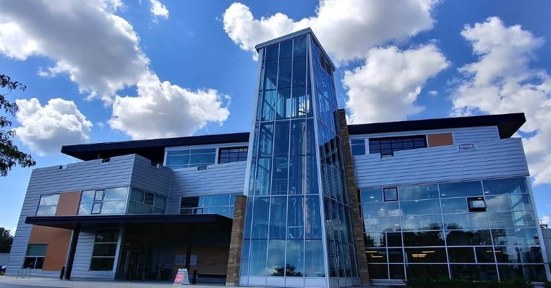 New Riff Distilling's main building, with lots of windows and the three story copper still visible through the main tower.