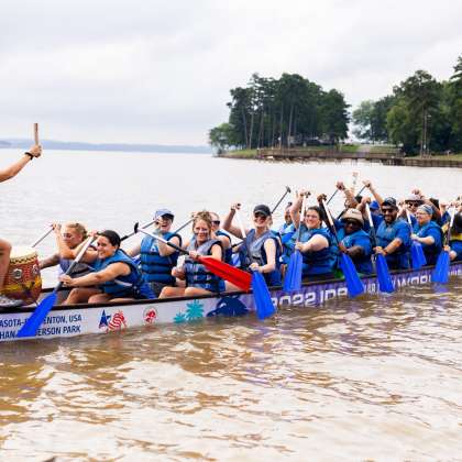 Group in a dragon boat at the 2024 Rowan County Chamber of Commerce Dragon Boat Festival