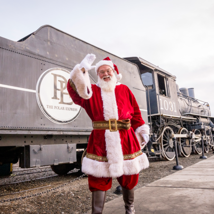 Santa waving in front of Polar Express