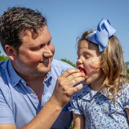 Little girl eating strawberry