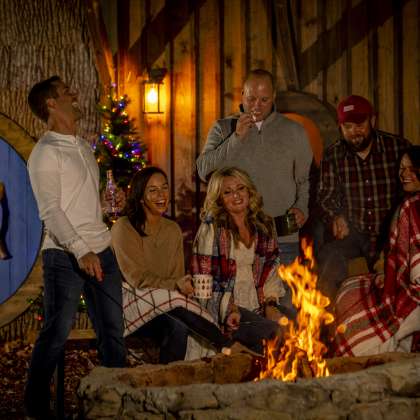 Friends and family around bonfire at Christmas
