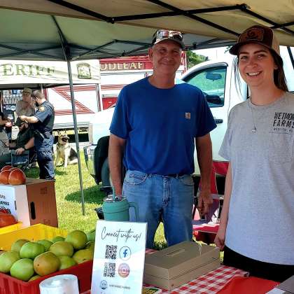 Two people at produce tent