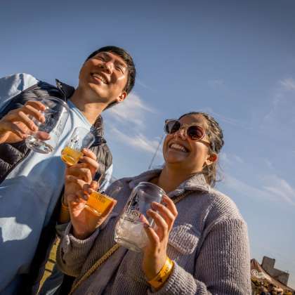 People smiling holding beer
