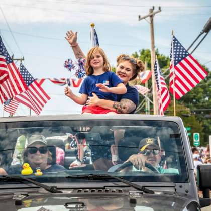 Family in truck at 4th of July parade