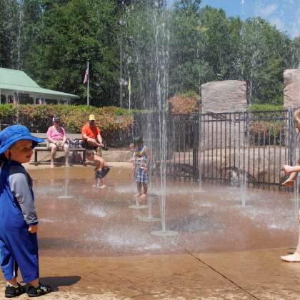 Kids playing in water plaza at Dan Nicholas