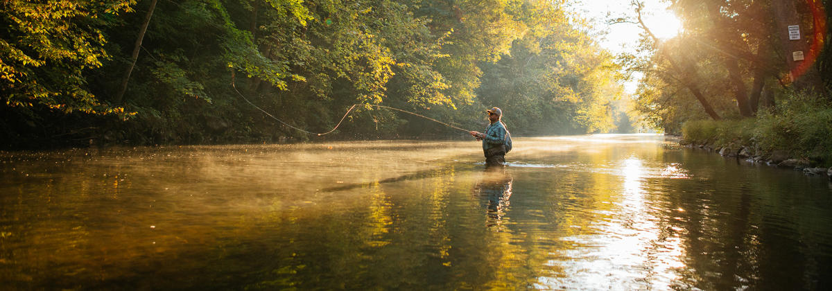 Man wading in the Yellow Breeches Creek fishing