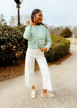 Woman Dressed for the Masters Tournament in light jacket and white pants from The Swank Company