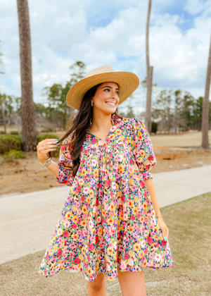 Woman Dressed for the Masters Tournament in a knee length sun dress and straw hat from The Swank Company