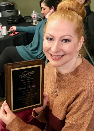 Carrie Chavez holding plaque