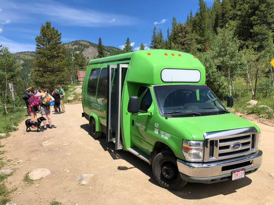 Hikers gathered on the green shuttle van for the Hessie Trailhead