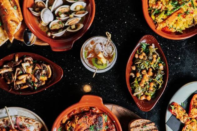 Aerial view of table covered with several dishes of Spanish foods