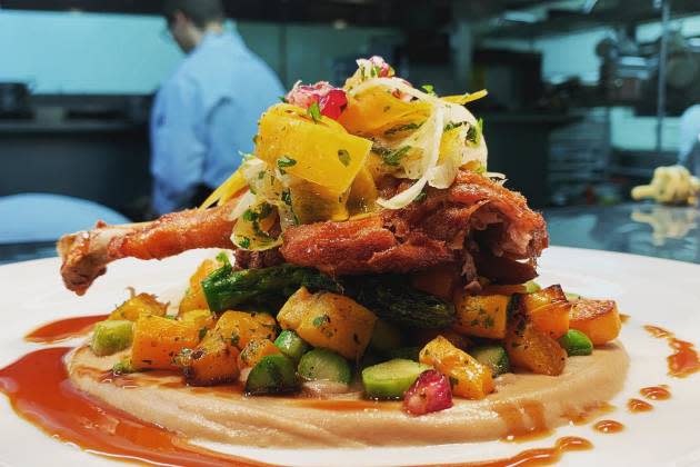 Plated lamb chop topped with fruit