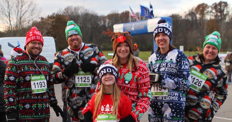 family dressed in christmas pajamas after running a 5k race