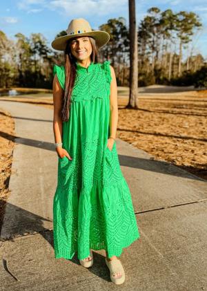 Woman wearing green maxi dress and a straw hat from Swank
