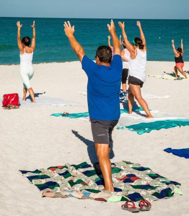 People enjoying yoga on Englewood Beach